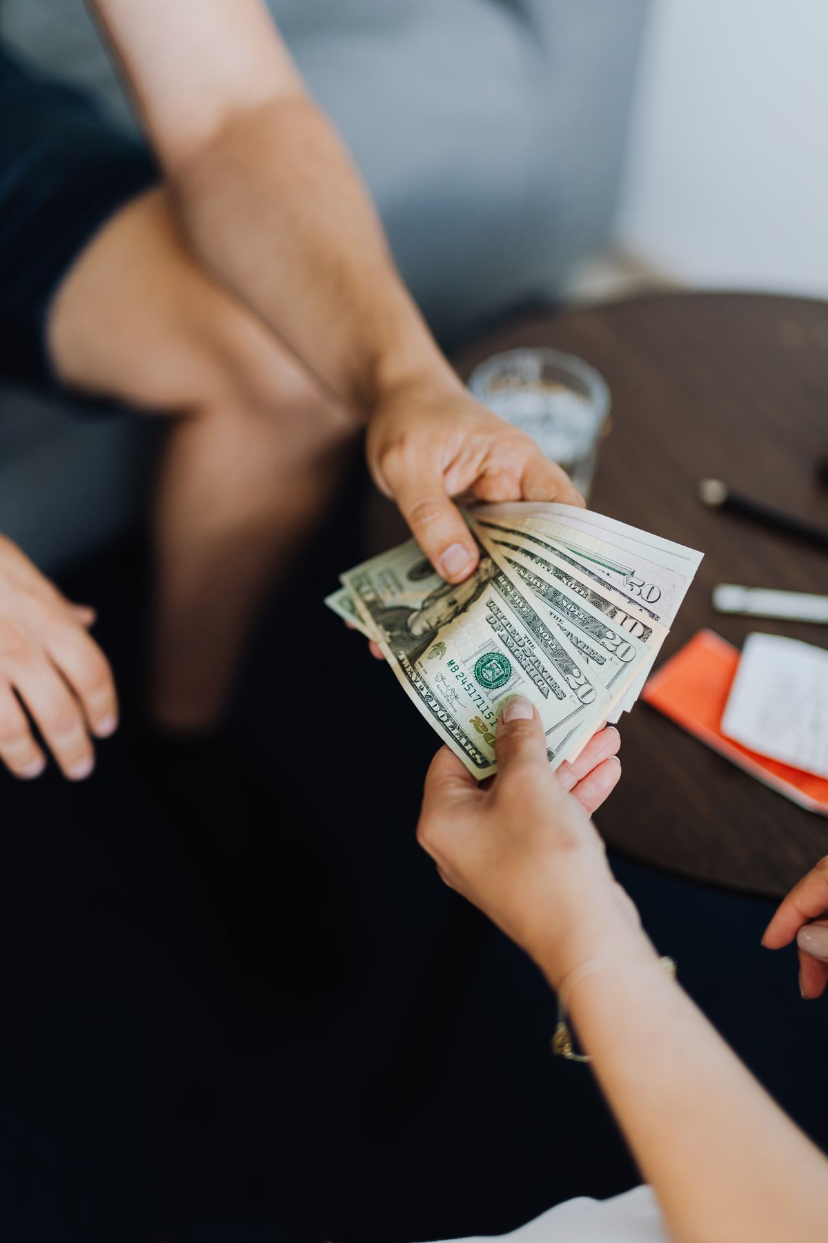 Cash being handed from one person to another