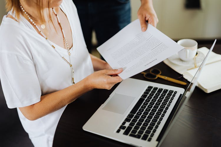 Man Handing Woman A Document 