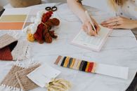Writing in Planner on Table