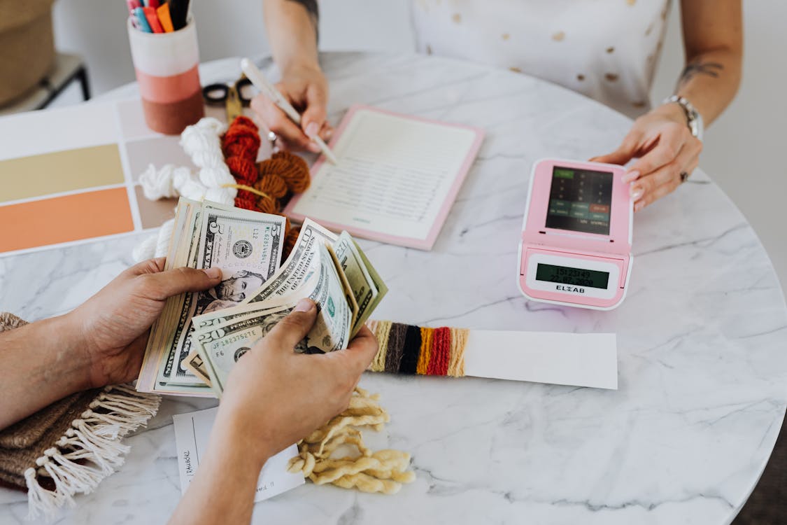 Free Hands Holding US Dollar Bills Stock Photo