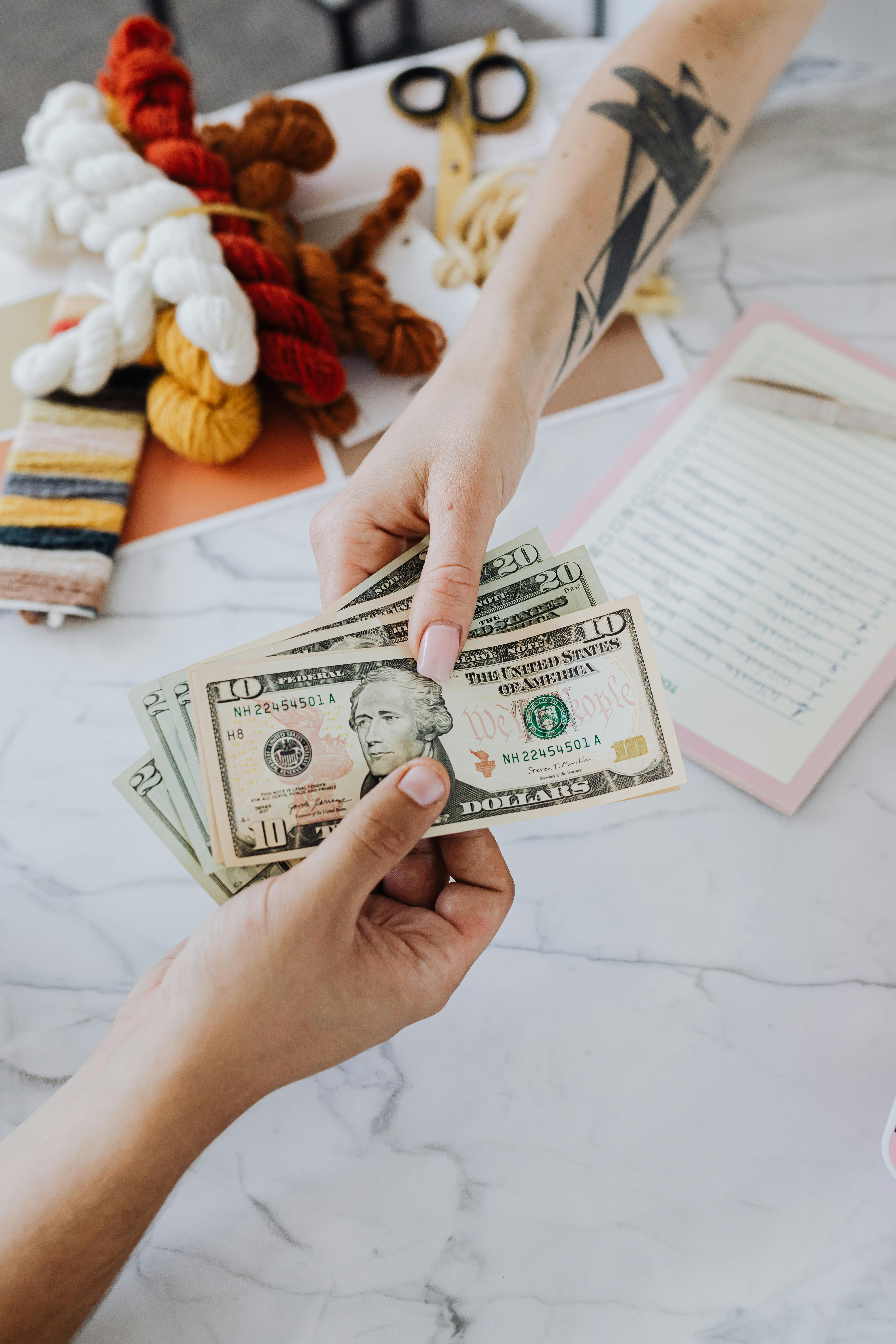 hands exchanging dollars