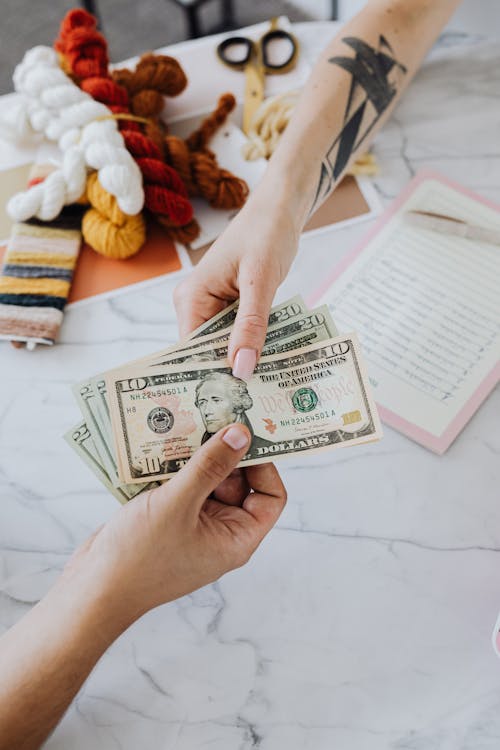 Free Hands Exchanging Dollars Stock Photo