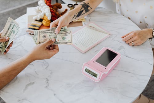 Free Hands Holding US Dollar Bills Stock Photo