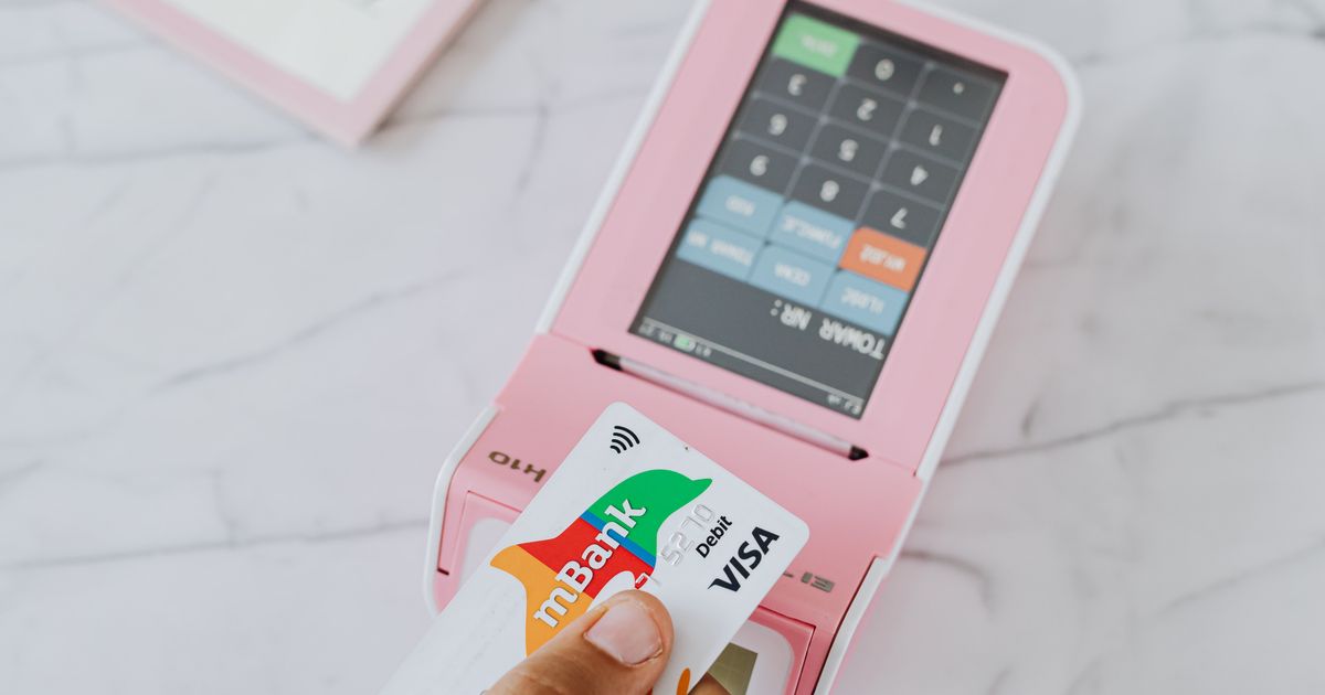 Person paying with credit card swipe POS machine