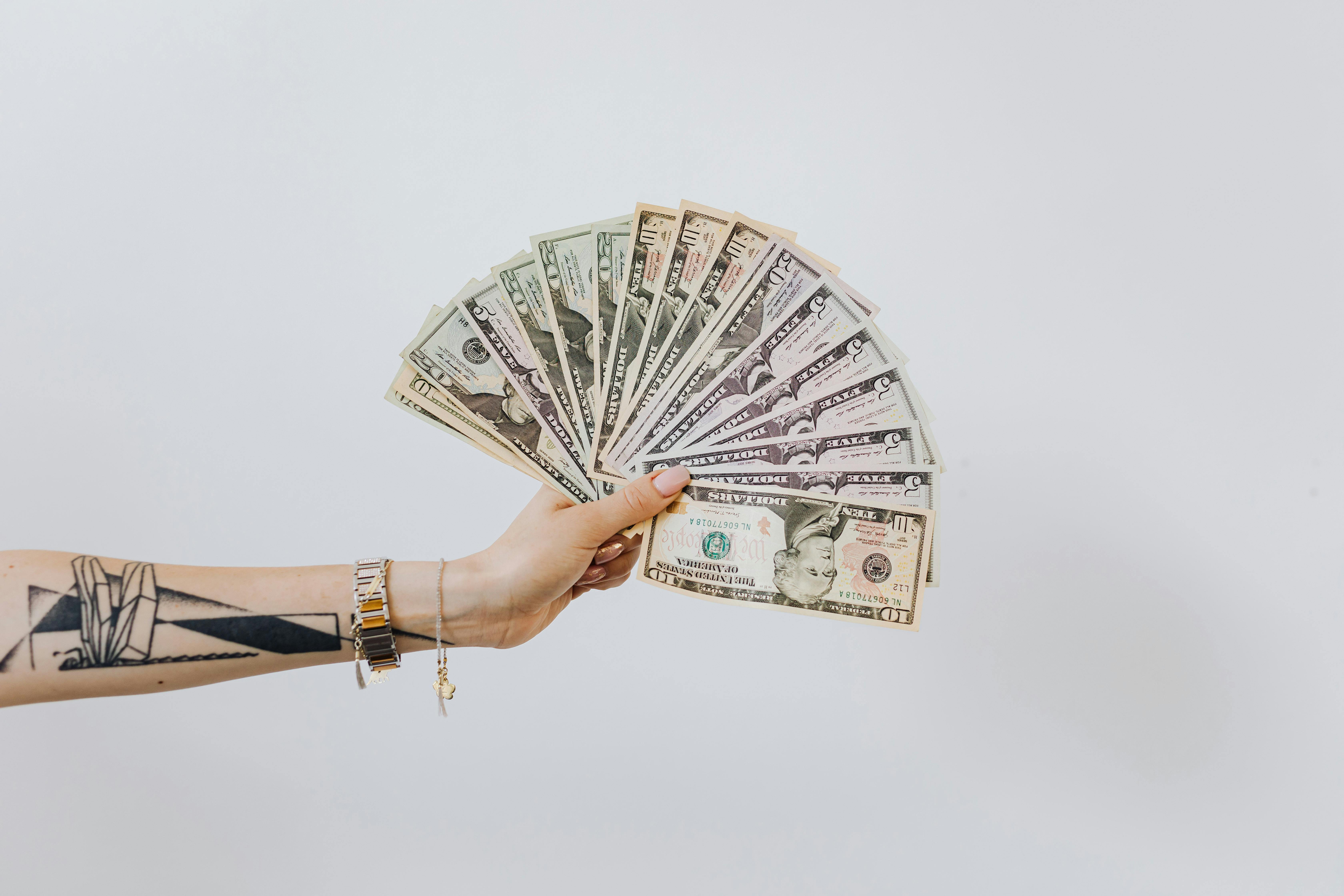 Hand Holding Fan of Us Dollar Bills \u00b7 Free Stock Photo