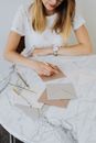 A Woman Writing on Envelopes