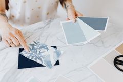 Designer comparing colour swatches on a marble table, photo by kaboompics.com on Pexels