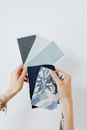 Woman Holding Paper Paint Samples and Fabric Samples 