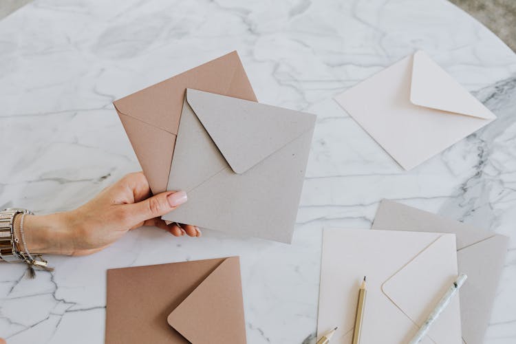 Close Up Of Woman Hand Holding Envelopes