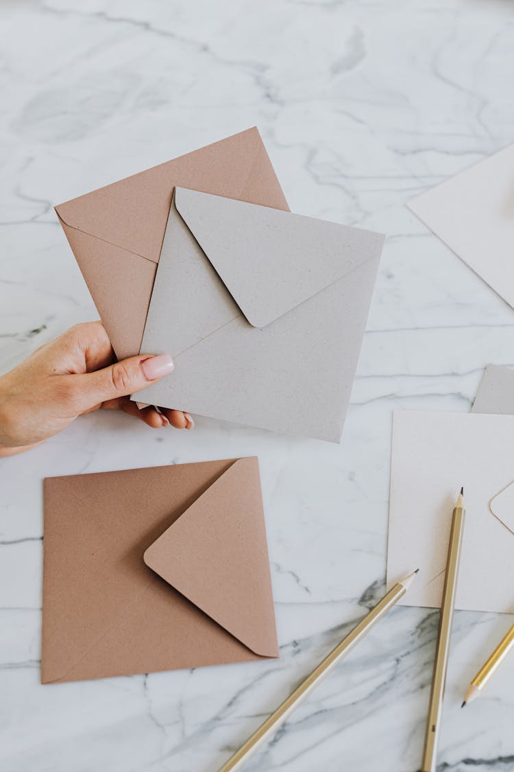 Close-up Of Woman Showing Handmade Paper Envelopes