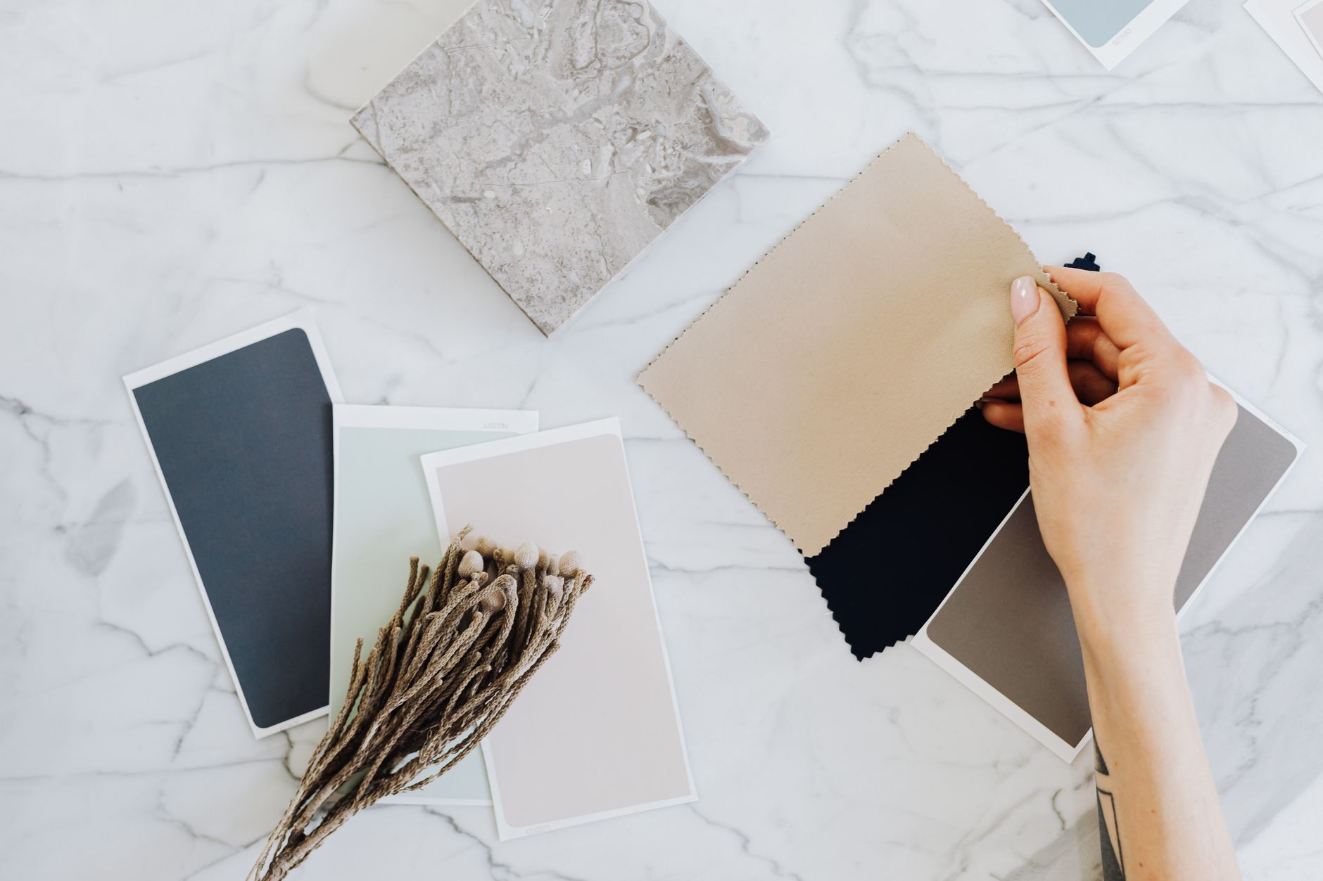 A small selection of coordinated clothing pieces arranged flat on a neutral surface, representing a capsule wardrobe colour palette at the start of a cross-context compatibility assessmentSOURCE: Pexels | Unsplash | Pixabay