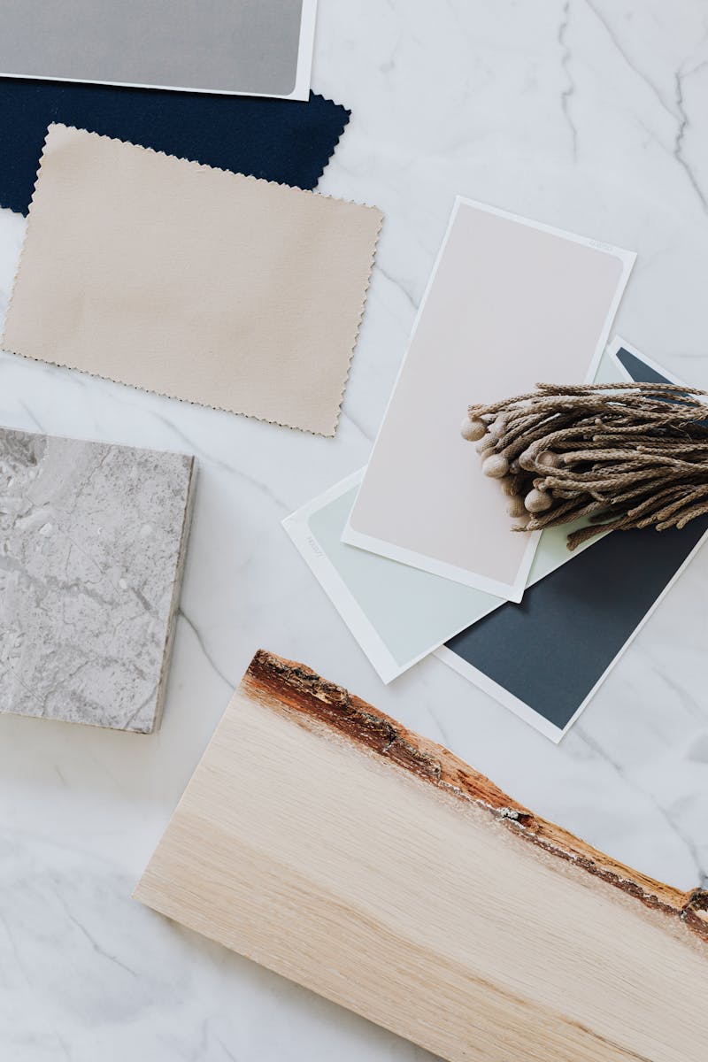 Material samples including wood, marble, and textiles for interior design