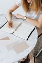 Woman in White Shirt Writing on White Paper