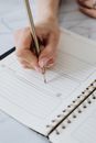Person Writing on White Ruled Paper