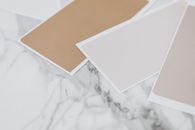 White Printer Paper on White and Brown Floral Textile