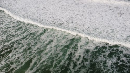 Free Captivating aerial view of ocean waves at Woonona Beach, NSW, Australia, showcasing nature's beauty. Stock Photo