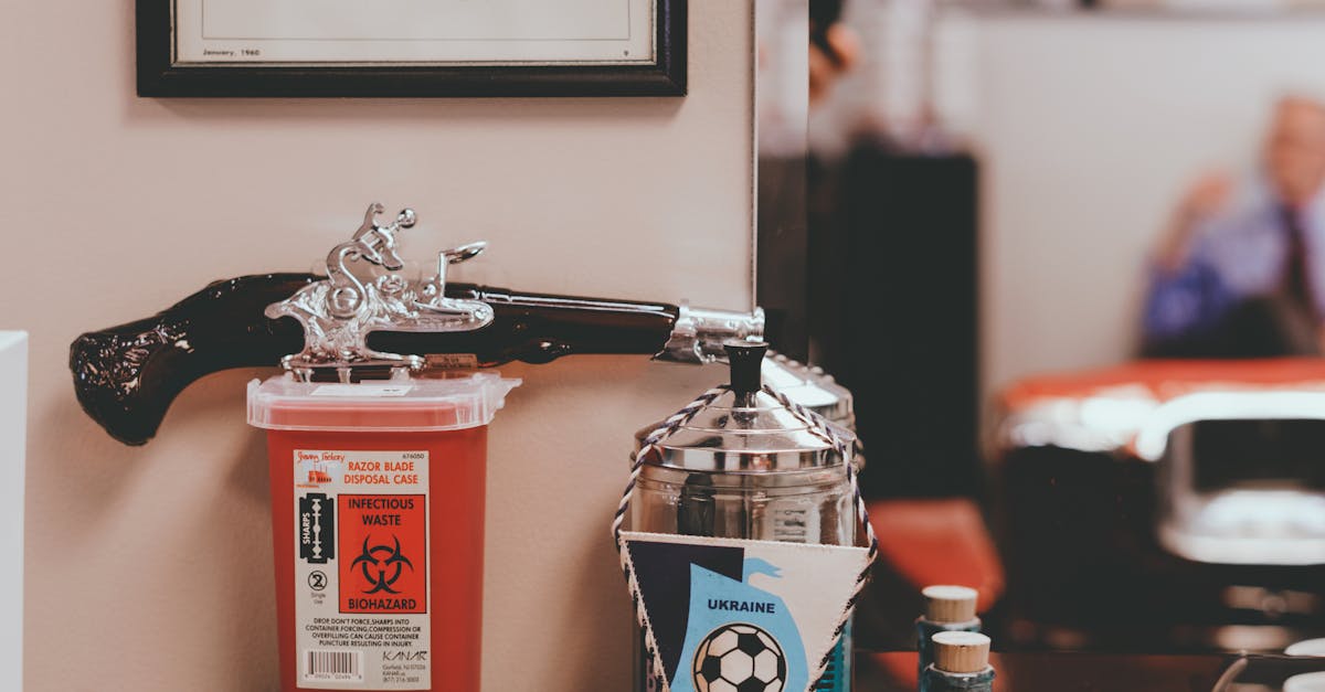 Various hair care products and comb placed near mirror on wooden table of old fashioned barbershop