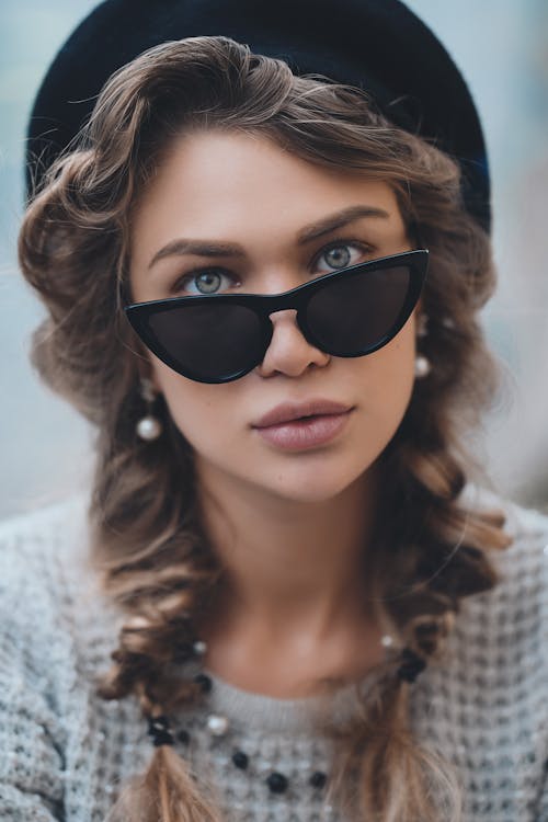 Stylish woman in sunglasses looking at camera