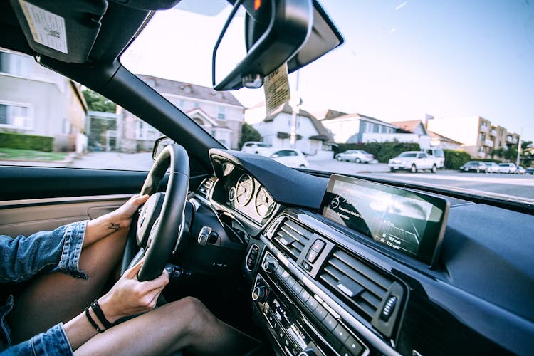 Anonymous Woman Driving Car In Town