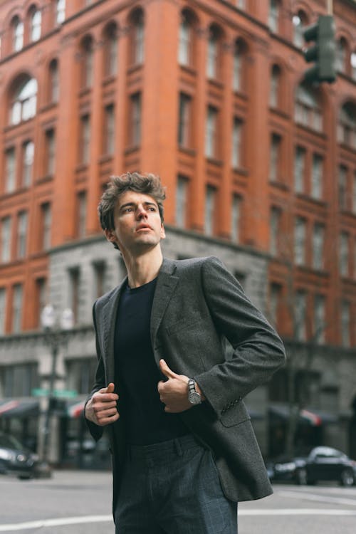 Man in Black Coat Standing Near choize building uk