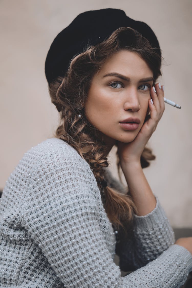 Woman In Beret With Cigarette Touching Face