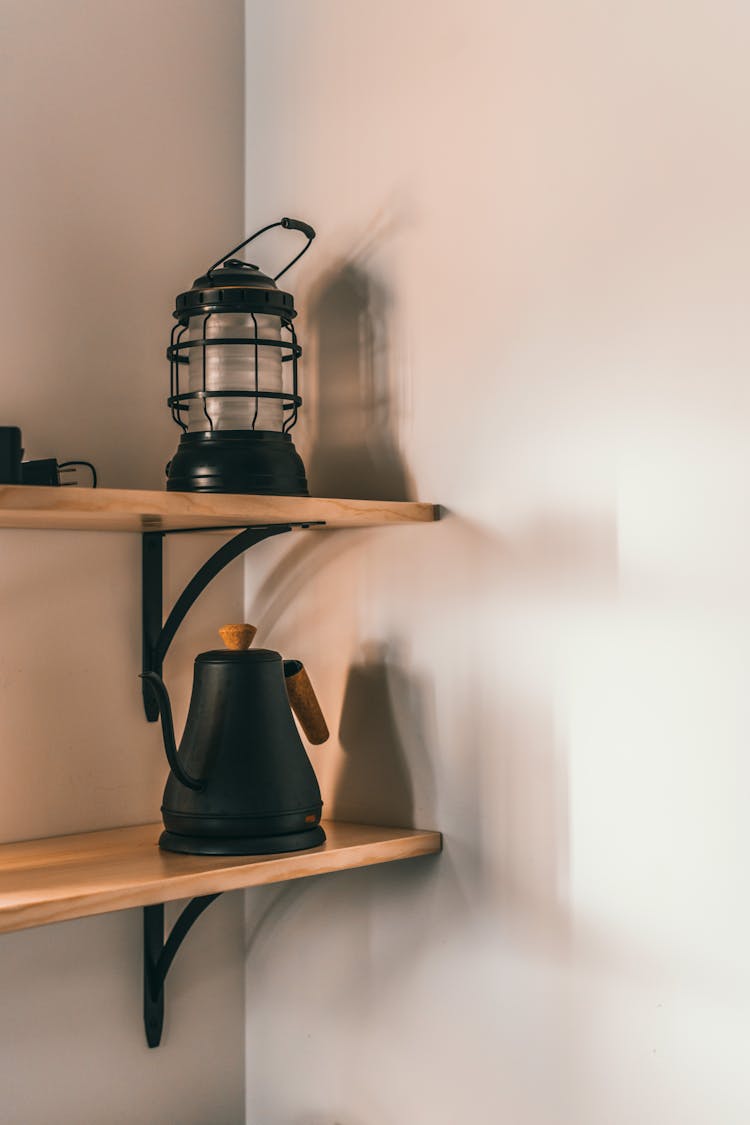 Kettle And Lantern On Shelves At Home