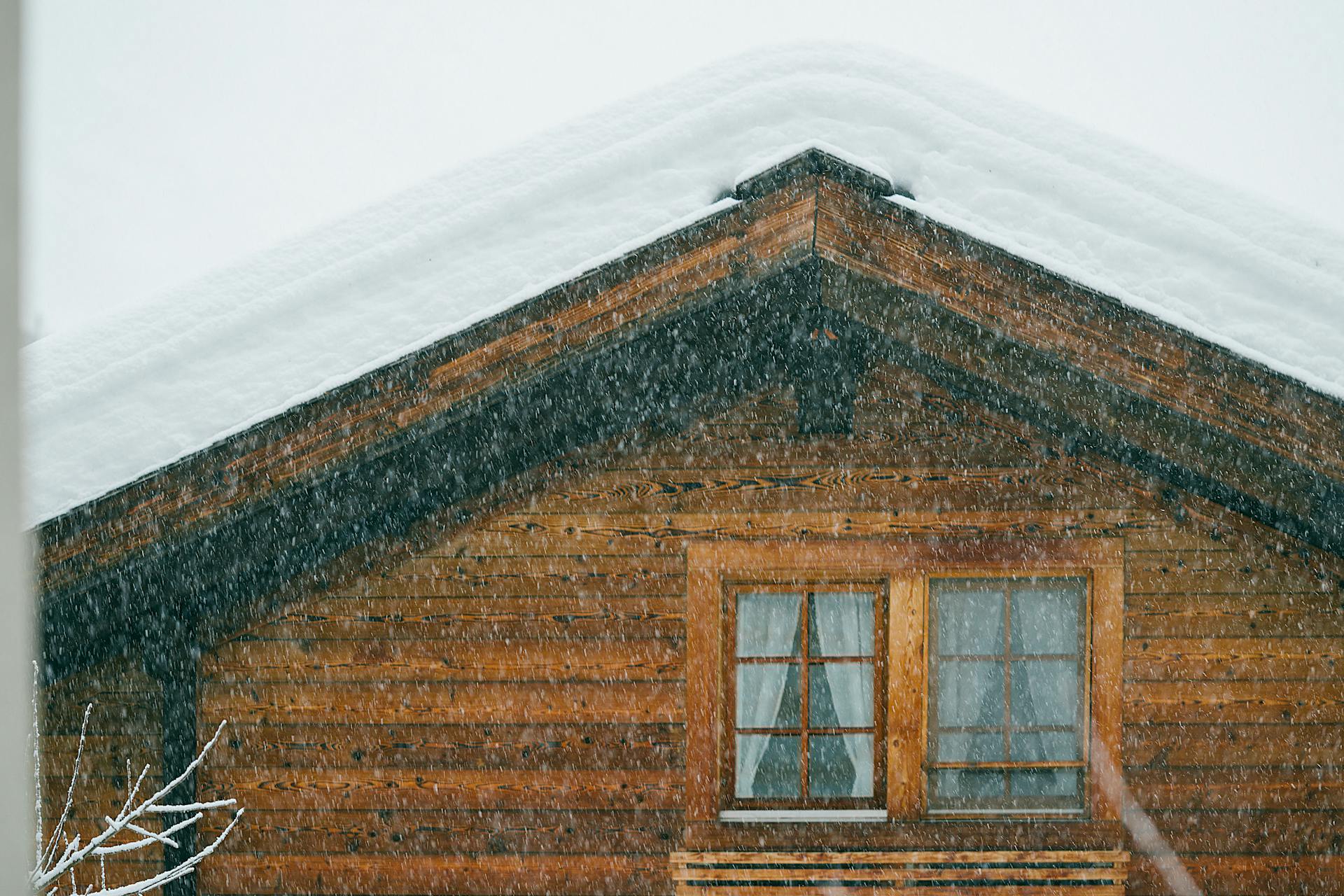 Aged building facade with snow on roof