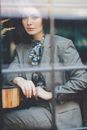 Stylish woman in formal wear at table