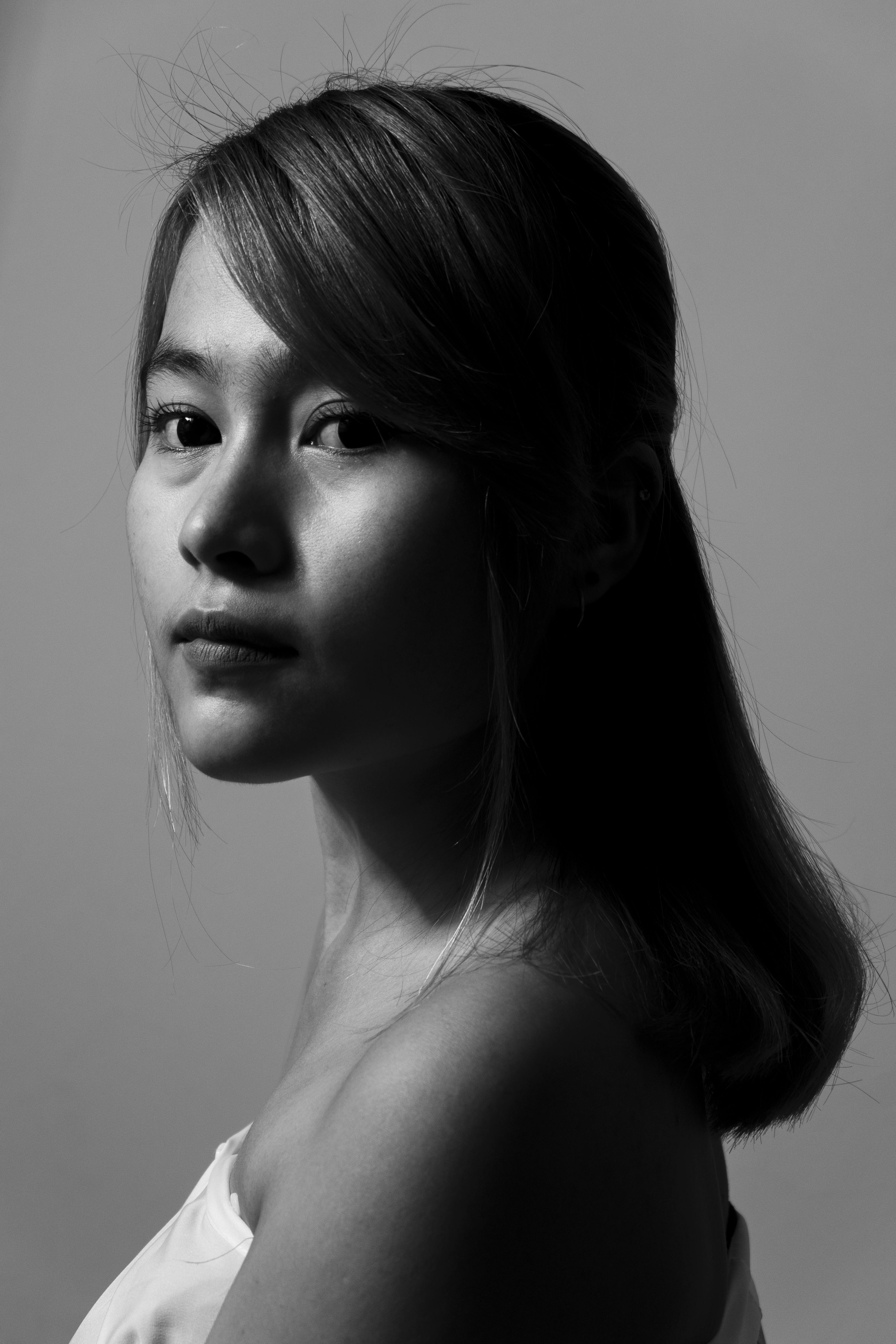 Artistic black and white portrait capturing an elegant young woman.