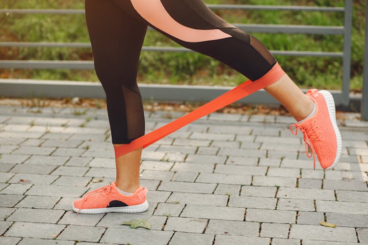 Close-up Of Woman Training With Fitness Band