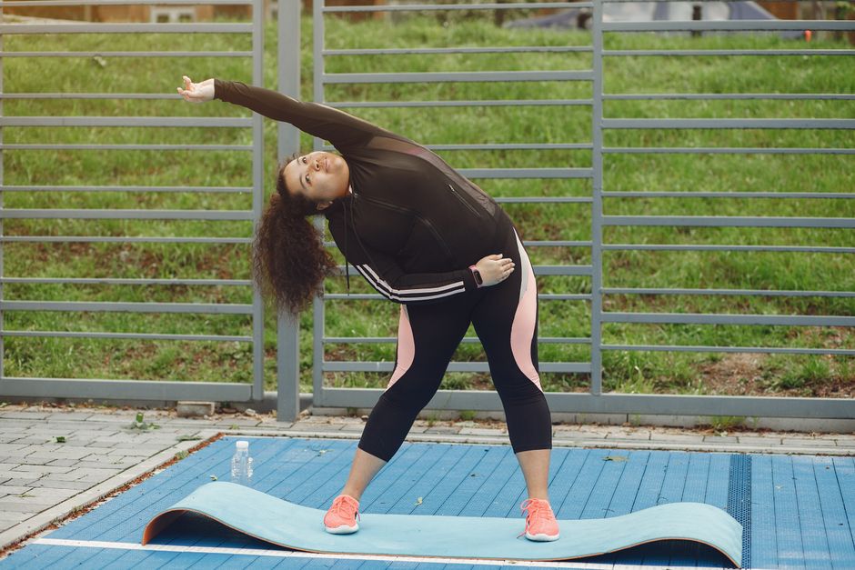 A person sitting on a yoga mat performing a gentle hamstring stretch with proper alignment and focus - how to exercise daily A person sitting on a yoga mat performing a gentle hamstring stretch with proper alignment and focus - how to exercise daily