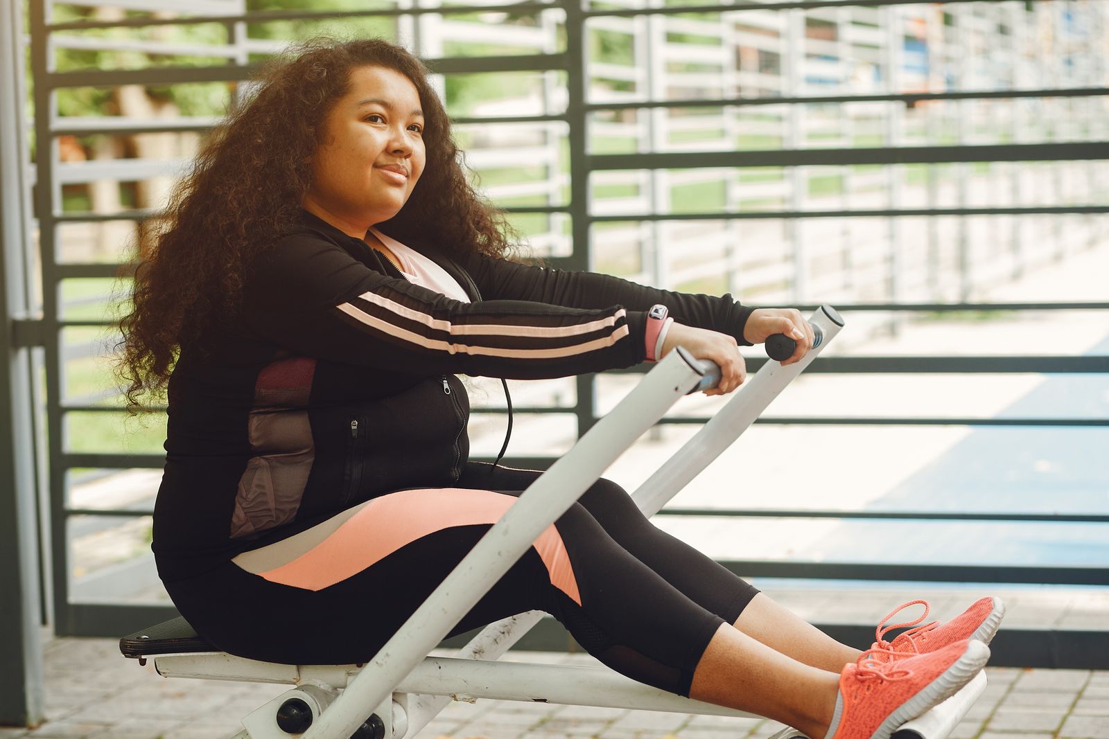 Woman in workout clothes exercising with focus, working toward a weight loss goal