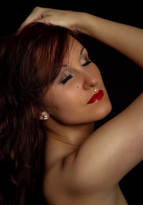 Free Artistic portrait of a woman with closed eyes and bold red lips, exuding elegance and glamour. Stock Photo