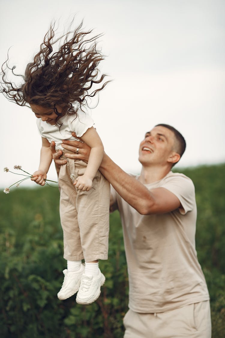 Father Lifting His Daughter 