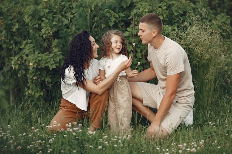 Family Together On Meadow