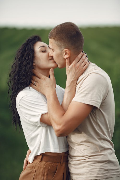 Free Couple Kissing on Field Stock Photo