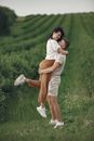 Man Picking Woman Up on Field