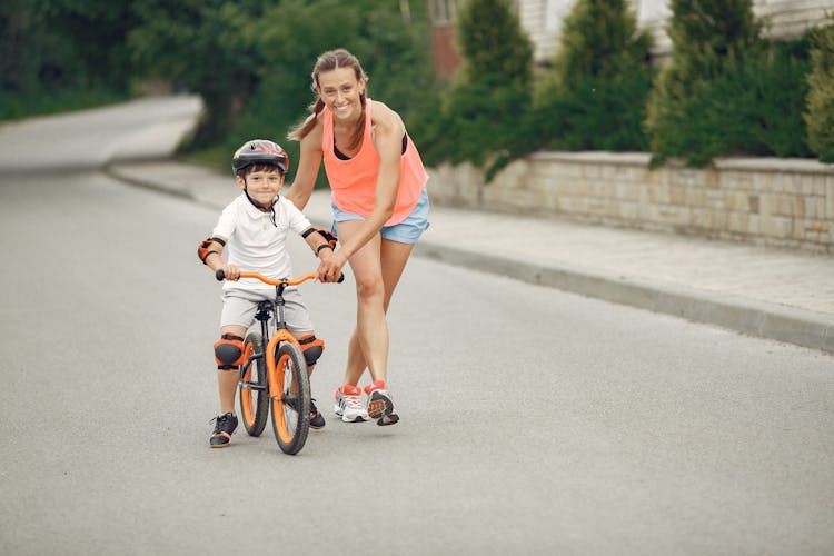 Mother Teaching Son To Ride Bike