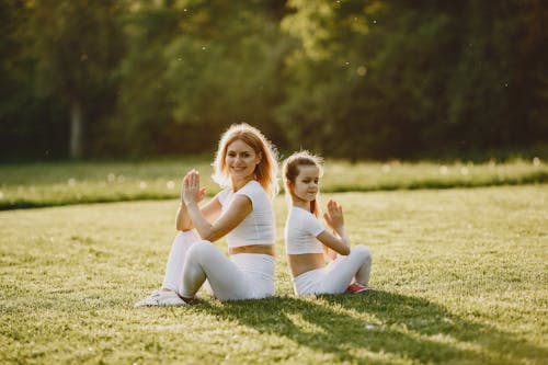 Free A Woman Doing the Easy Pose with her Daughter Stock Photo