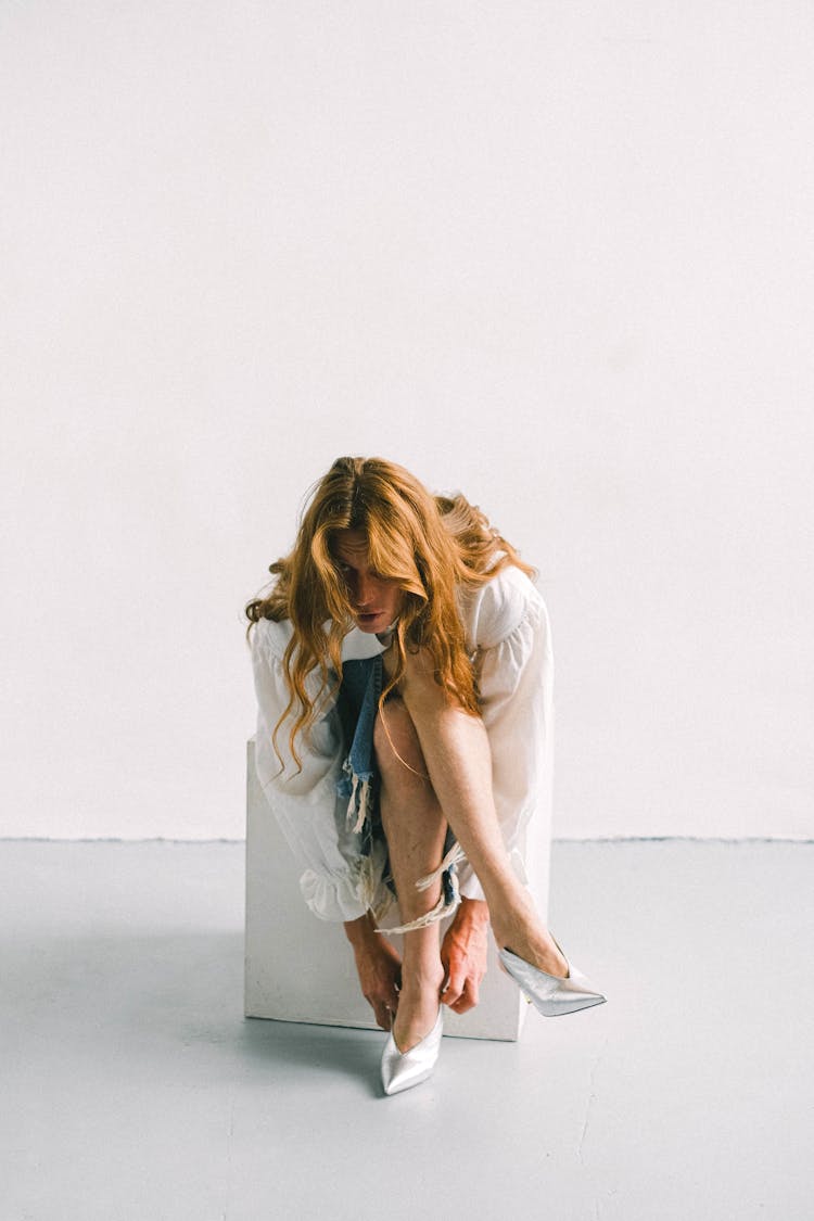 Anonymous Young Man Wearing Trendy Female Shoes In Studio