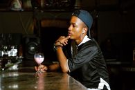 Young man sitting in a bar, pondering with a cocktail in Orapa, Botswana.