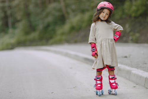 Free A Little Girl in Rollerblades by the Roadside Stock Photo