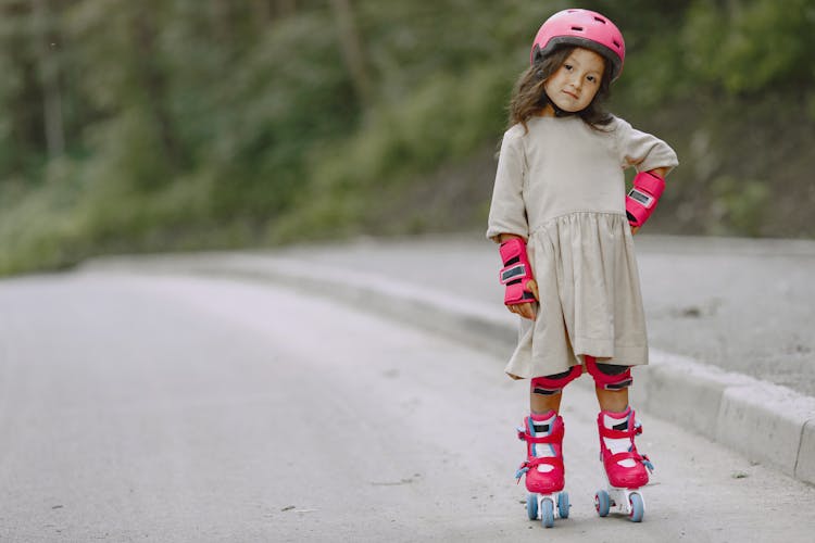 A Little Girl In Rollerblades By The Roadside