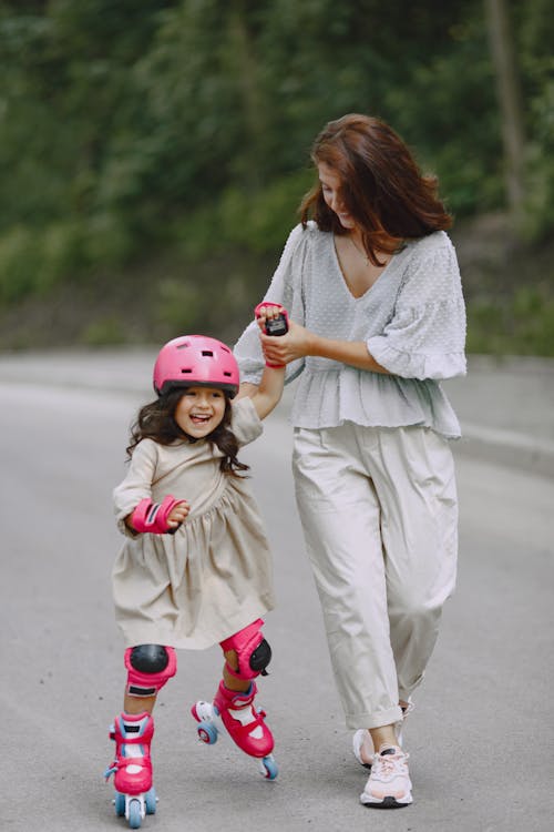 A Woman Teaching her Daughter how to Roller Skate