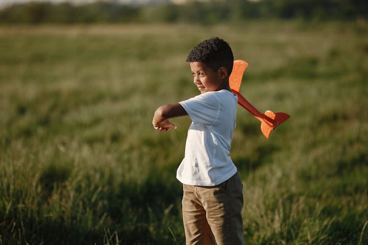 Boy Playing With Toy Plane