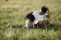 Boy in Meadow with a Dog