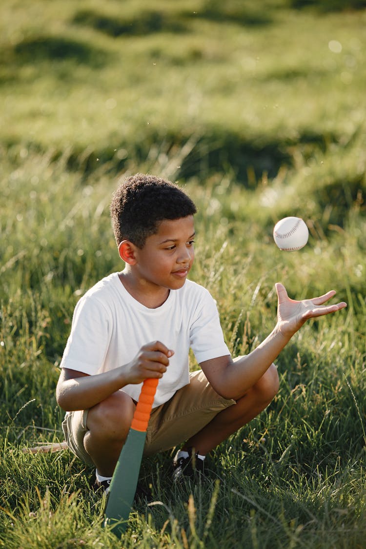 A Boy Playing With A Baseball