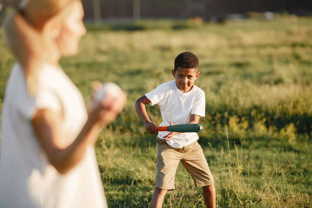 young boy practising his swing on a grassy field