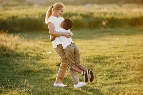 A Boy Hugging a Woman