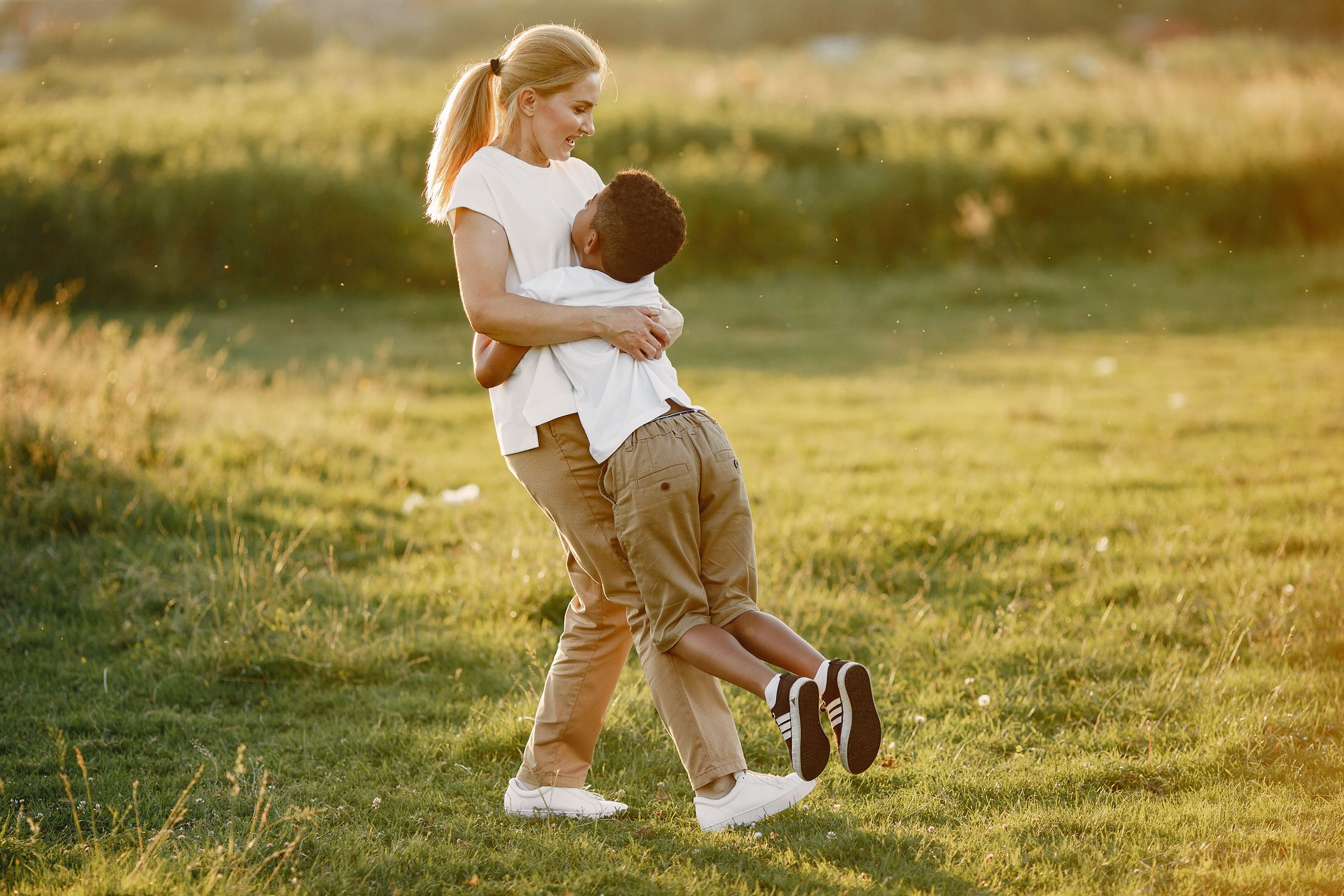 A Boy Hugging A Woman Free Stock Photo a-boy-hugging-a-woman-free-stock-photo